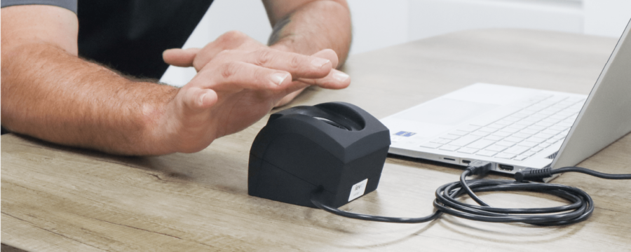 FAR and FRR in biometric security - ievo desktop biometric fingerprint enrolment reader being used next to a laptop