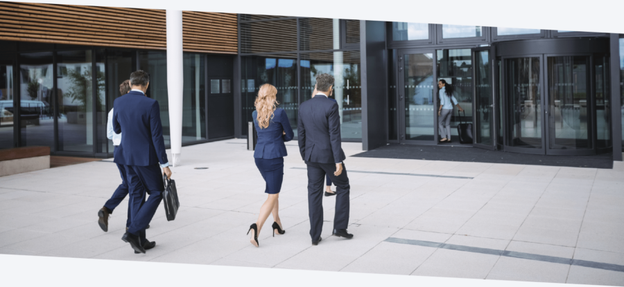 Business workers dressed smartly entering an office building