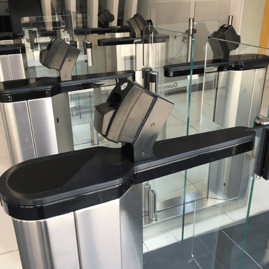 Turnstiles providing biometric access control with fingerprint readers mounted on top 